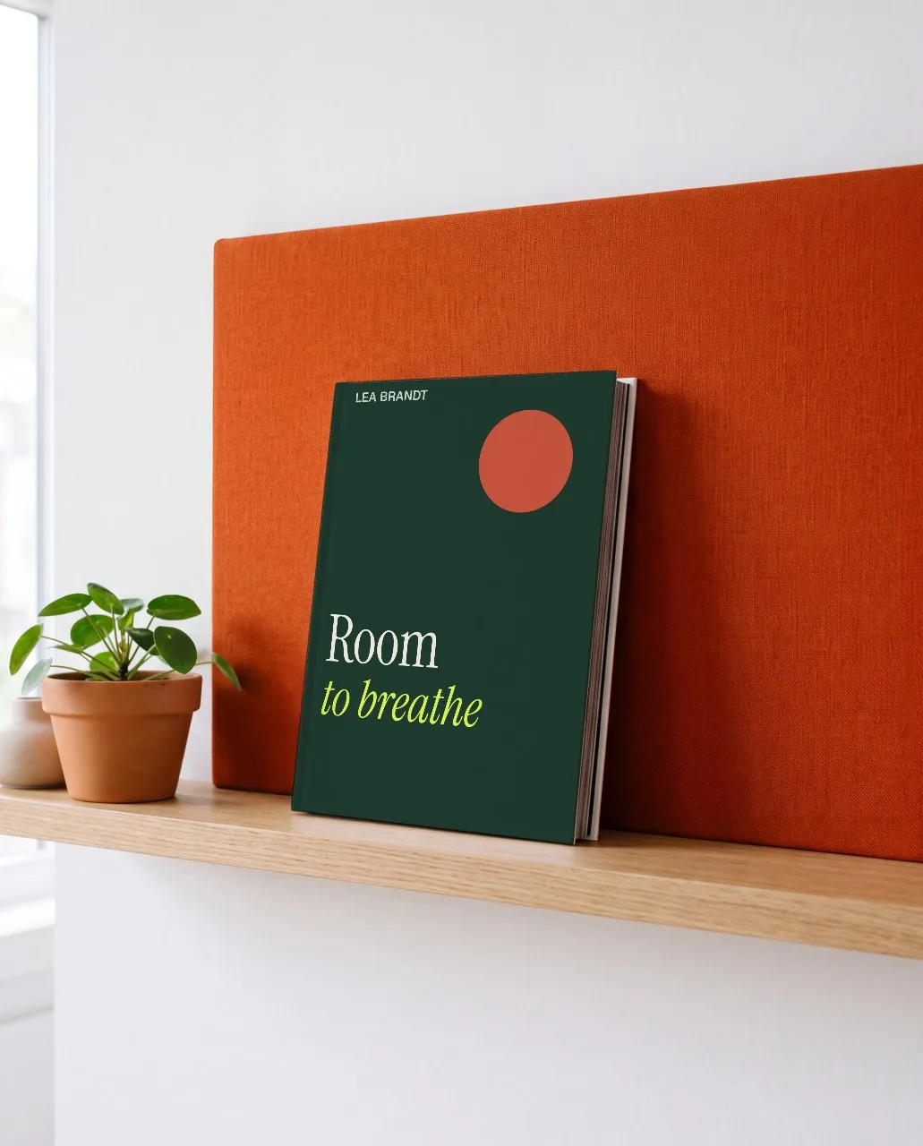 Book against an orange wall mockup