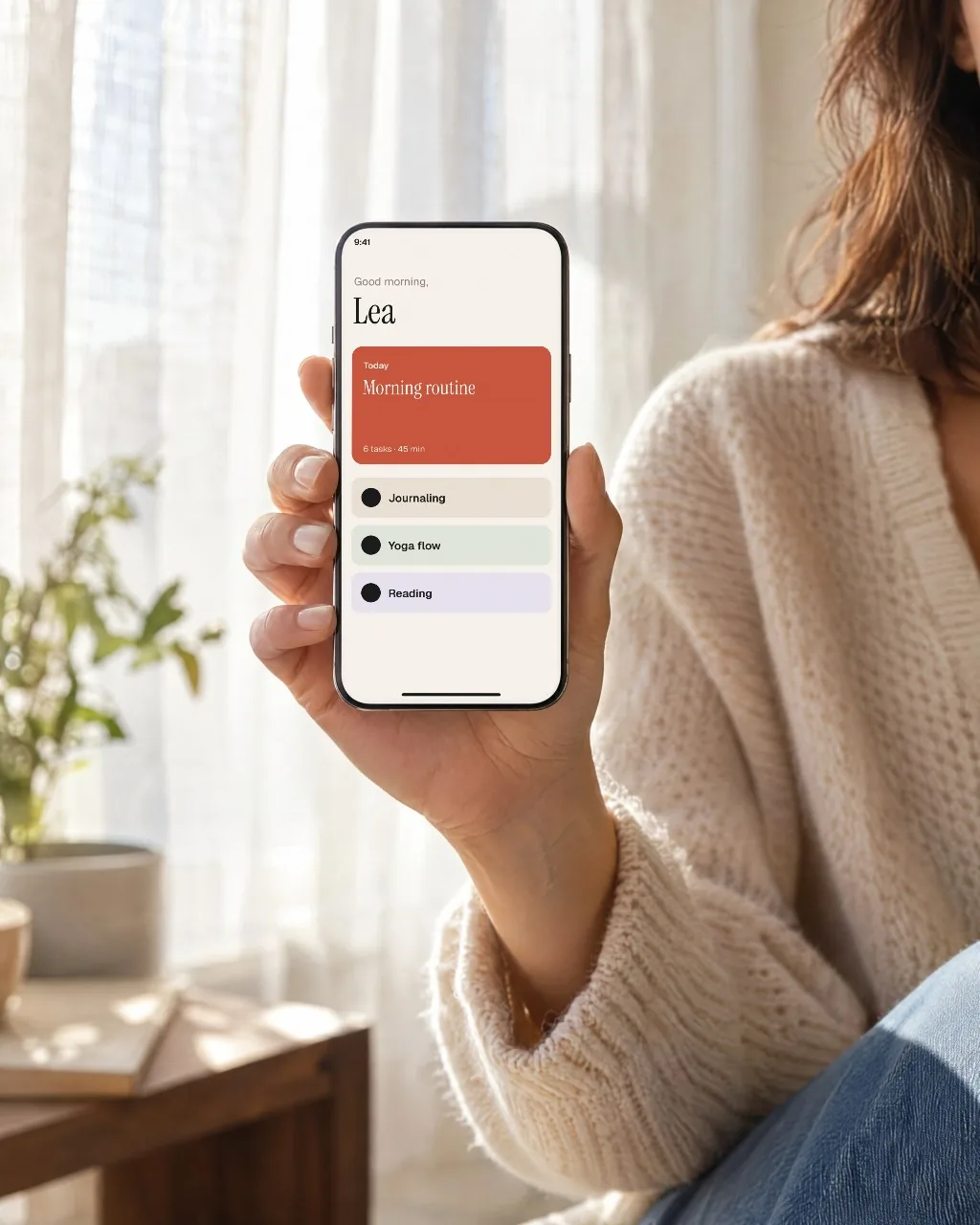 Phone in hand by a bright window mockup