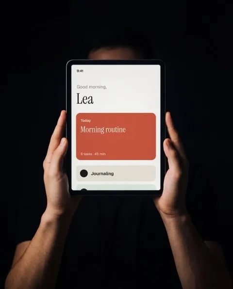 Tablet held overhead, black mockup