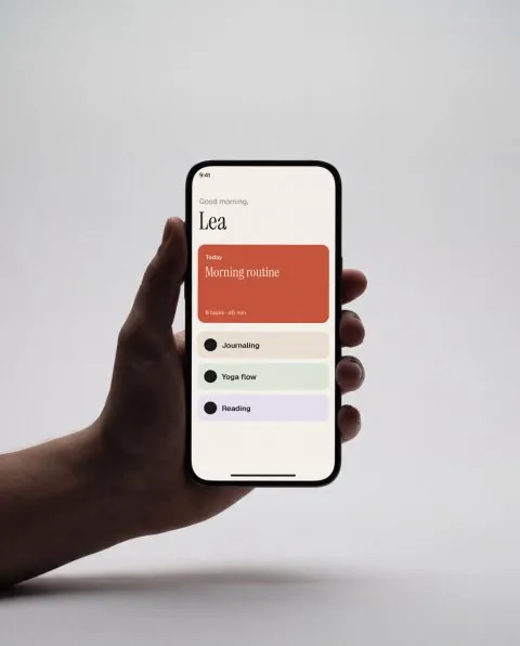 Phone in hand, grey studio mockup